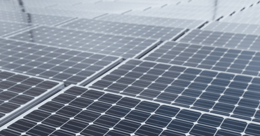 Solar panels arranged in a grid forming a solar farm.