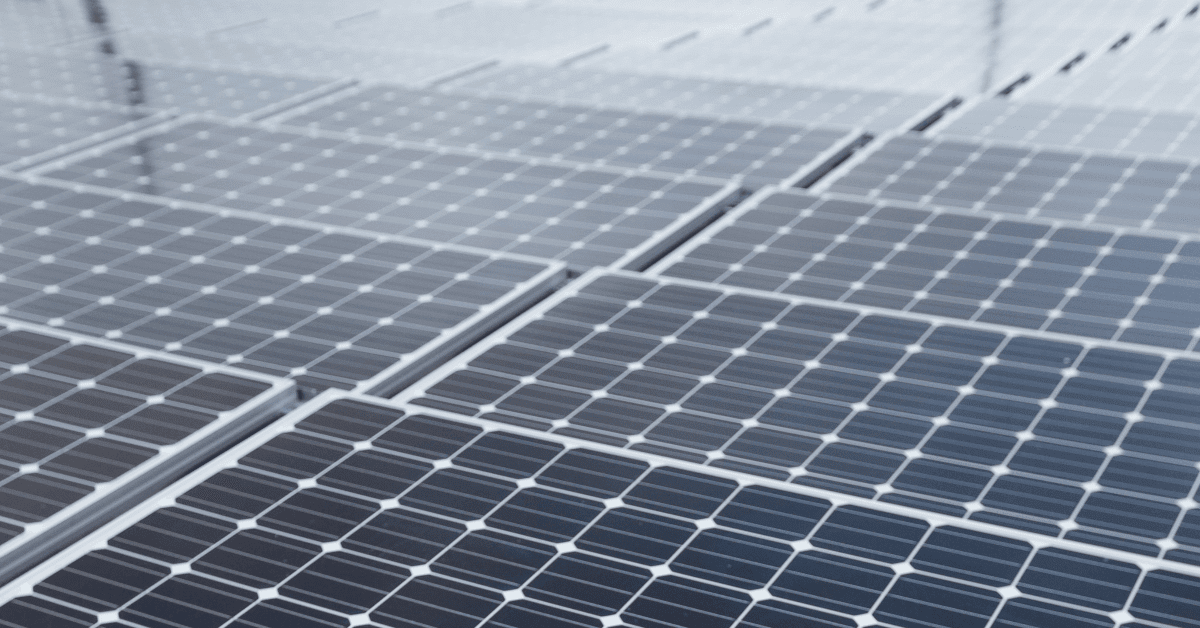 Solar panels arranged in a grid forming a solar farm.