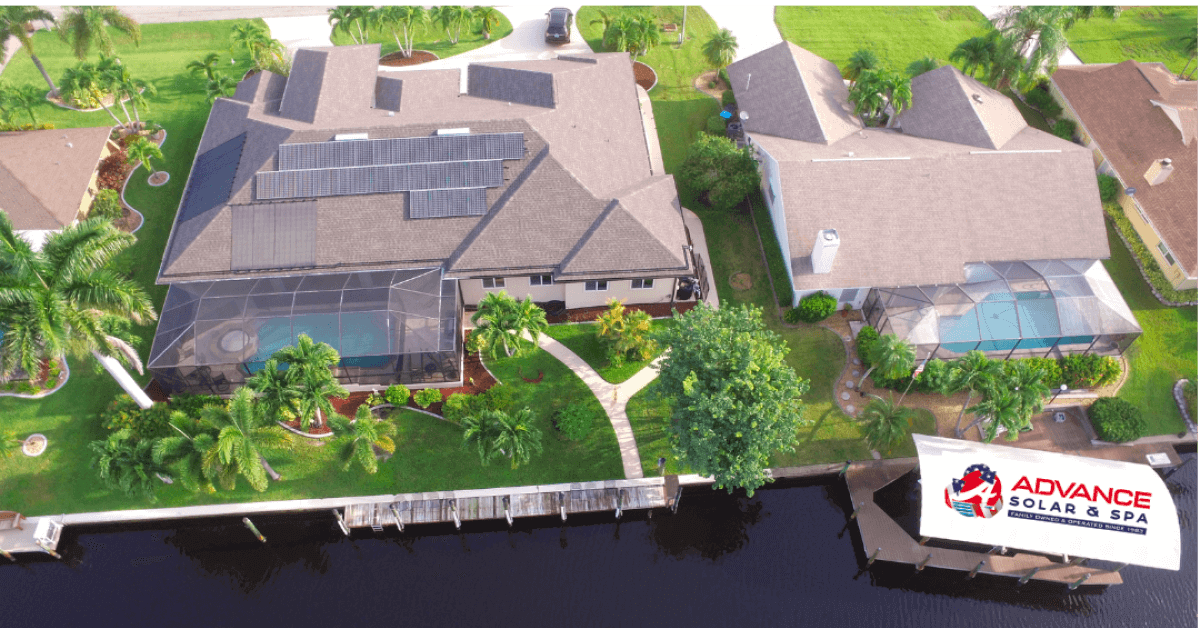 Aerial view of a lakeside neighborhood with solar panels on the left house and screened pool enclosures nearby
