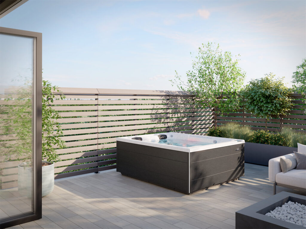 Rooftop terrace with a rectangular dark hot tub, potted plants, and a seating area under a clear blue sky.